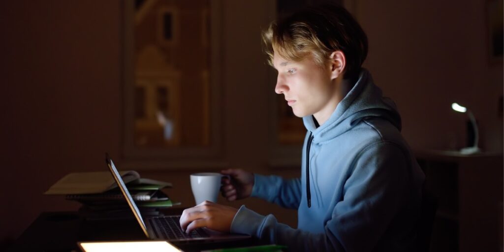 teen boy looking at computer screen