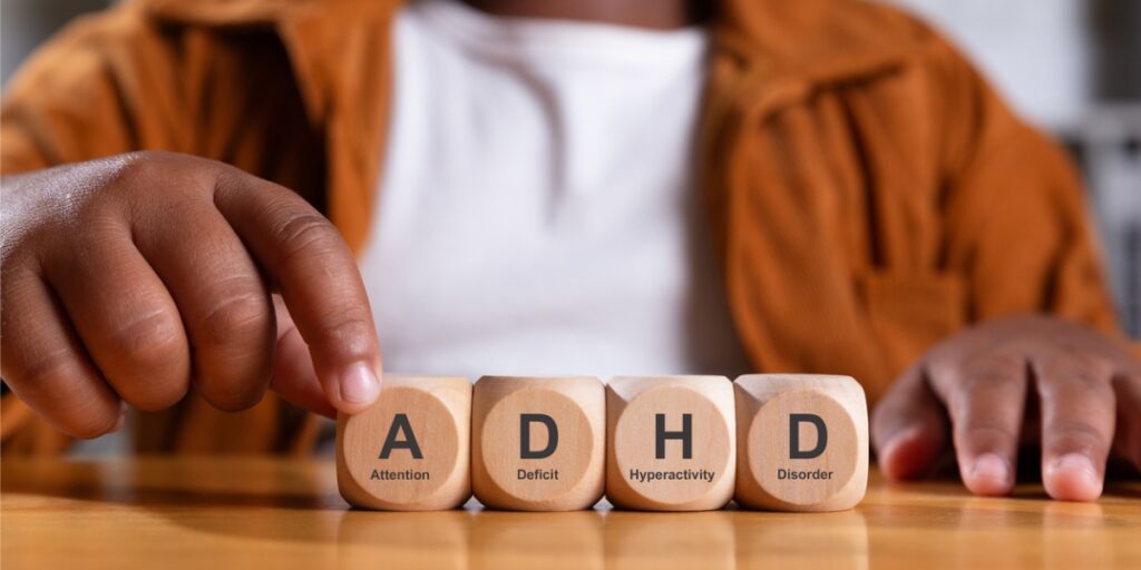 boy hand spelling adhd with cubes