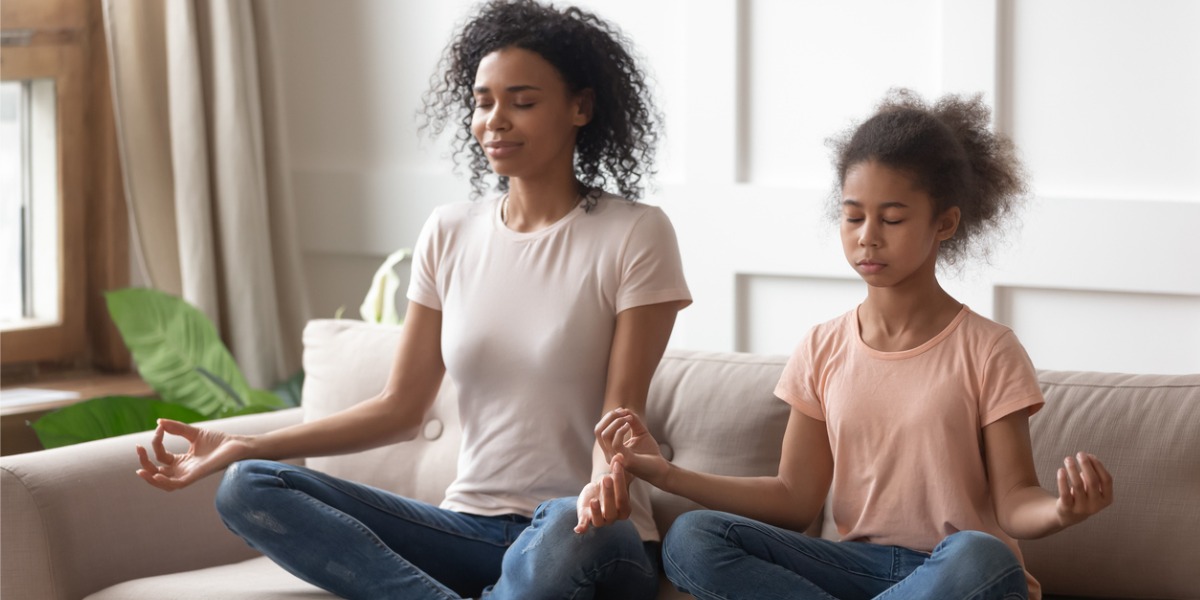 mother and daughter meditating together