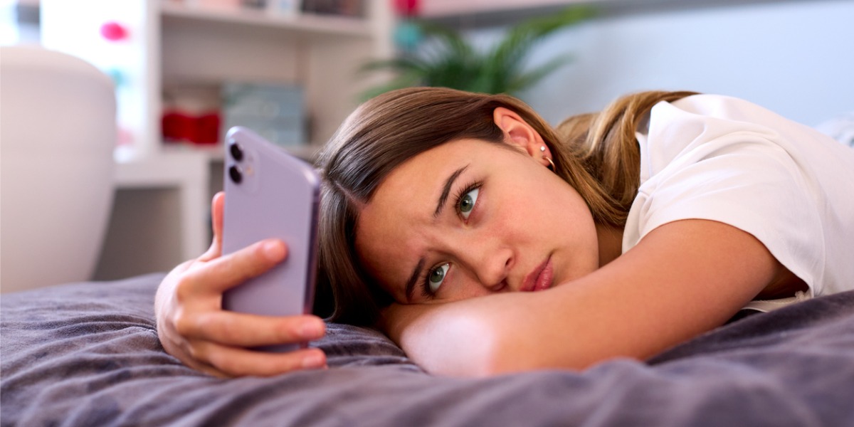 teen girl on phone experiencing anxiety