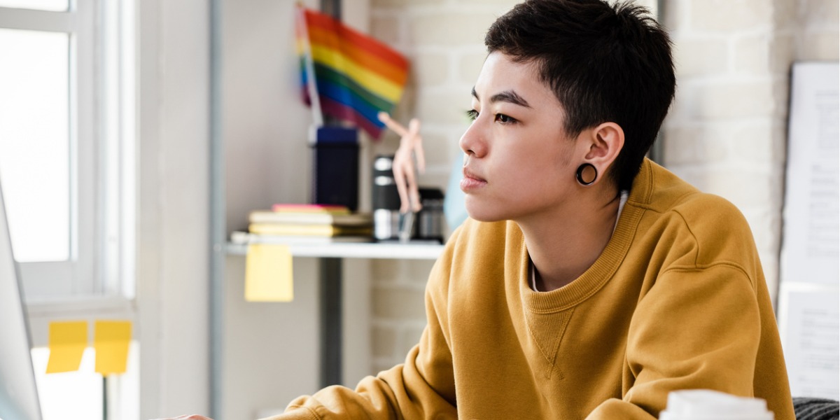 lgbtq teen looks at media on a laptop