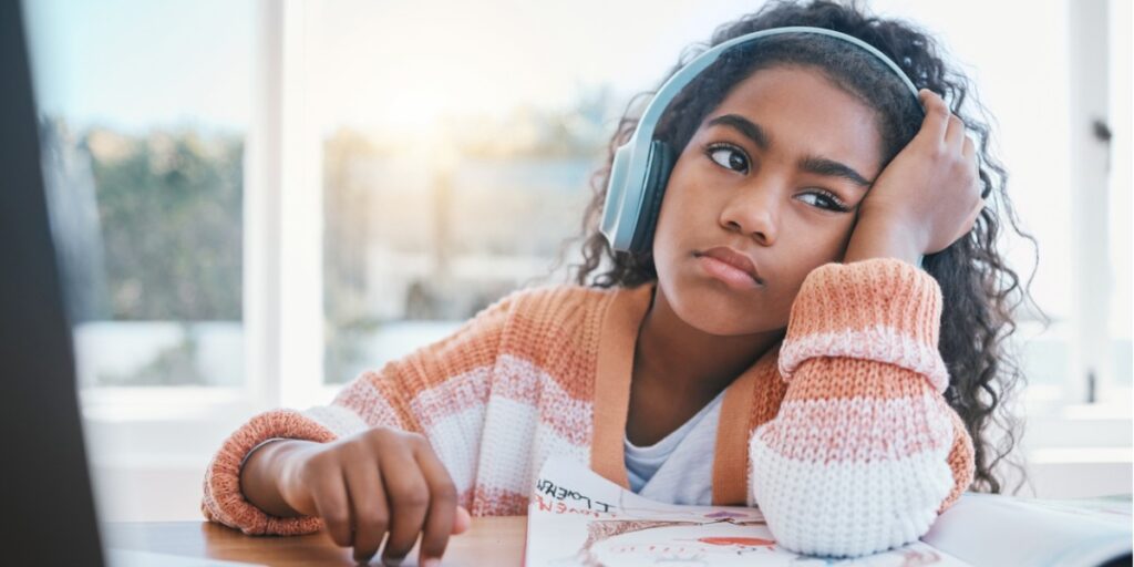 young girl distracted at computer because of adhd