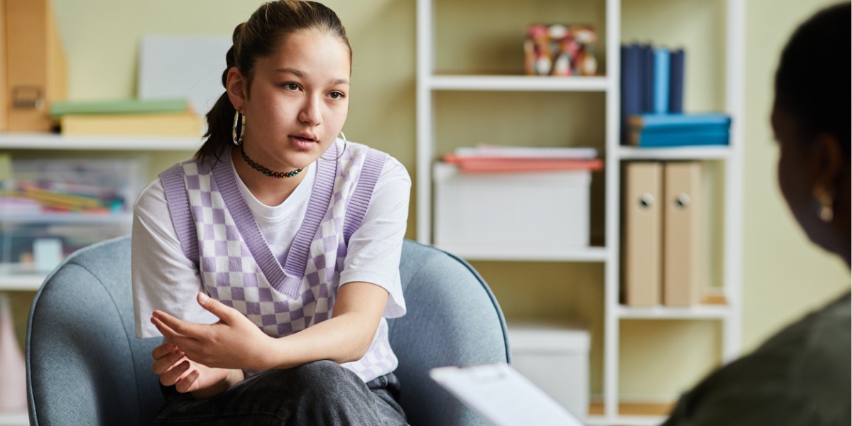 teen with depression talks to therapist in outpatient treatment