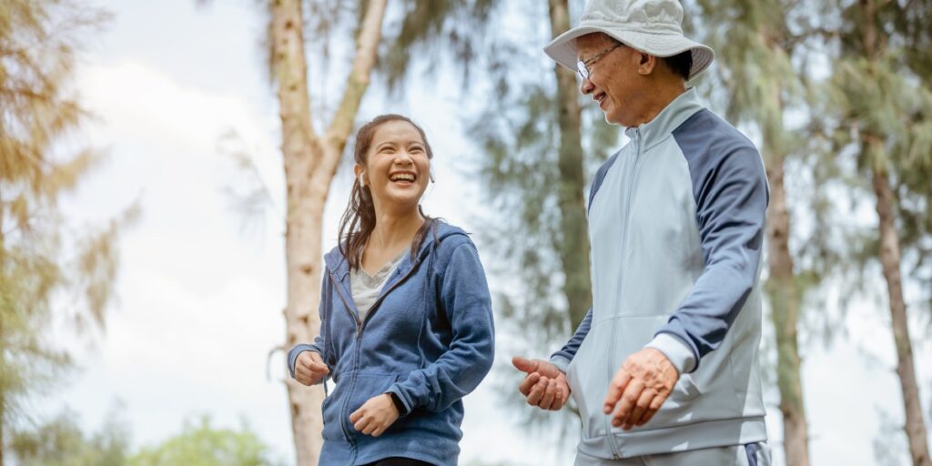 young woman and elderly man taking a walk