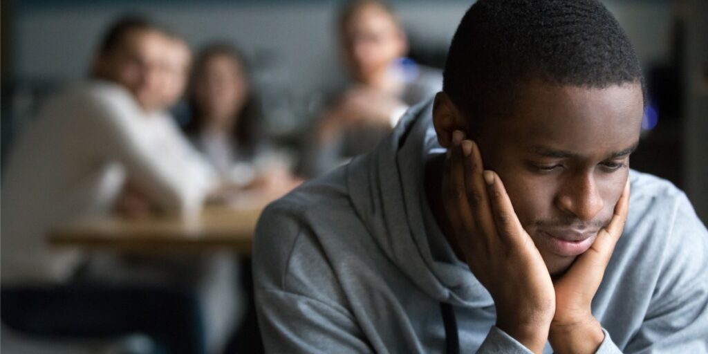 young black college student sitting isolated