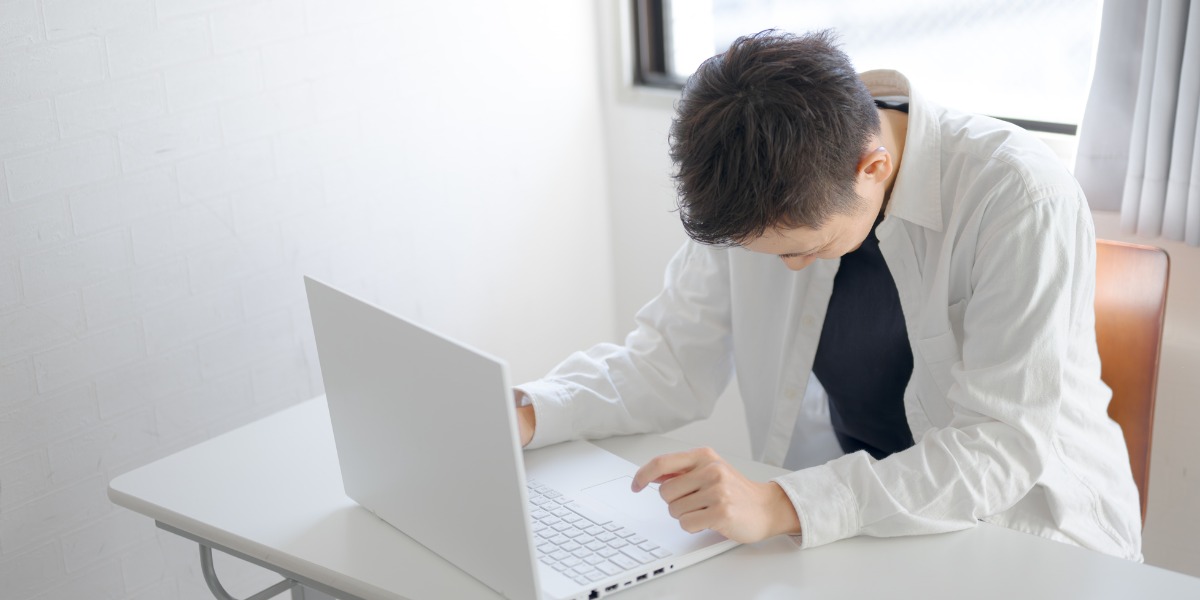 male college studemt looking depressed with laptop