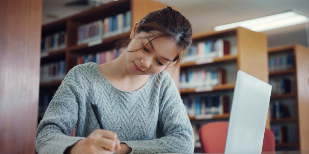 female college student studying in library