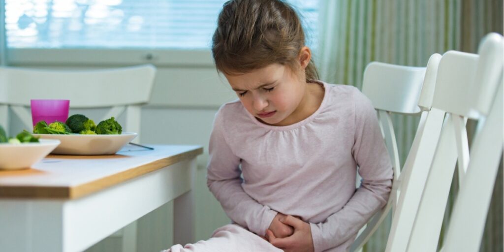 young girl holding stomach
