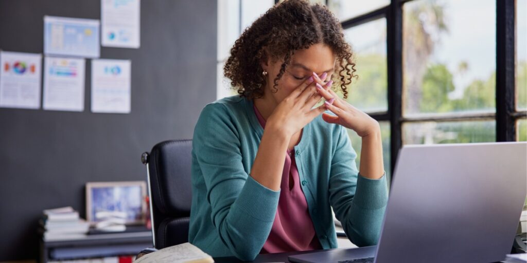 woman with head in hands stressed out