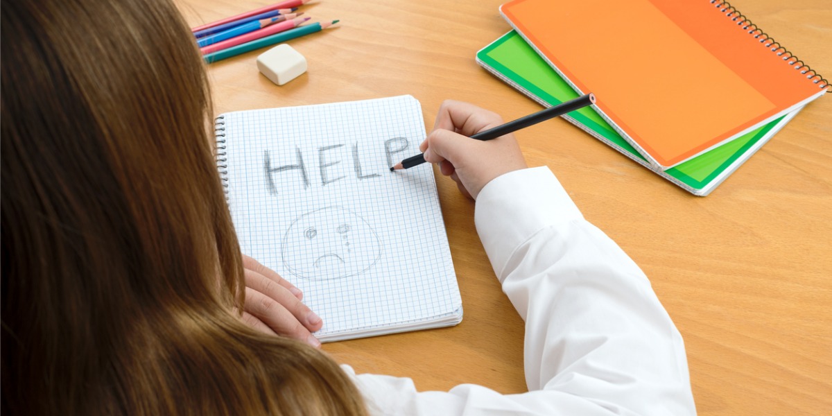 child writing help in notebook