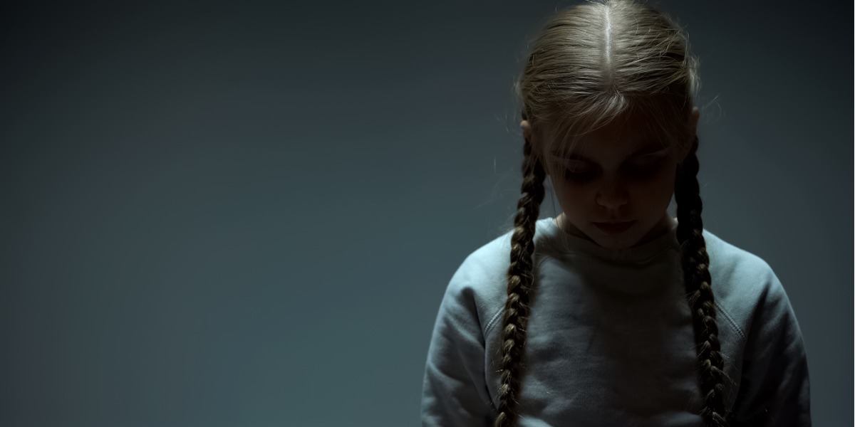 young girl looking sad due to adverse childhood experiences