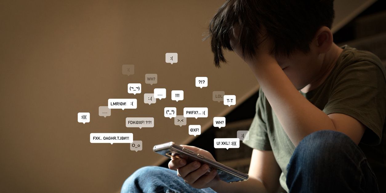 child overwhelmed looking at social media messages on his phone