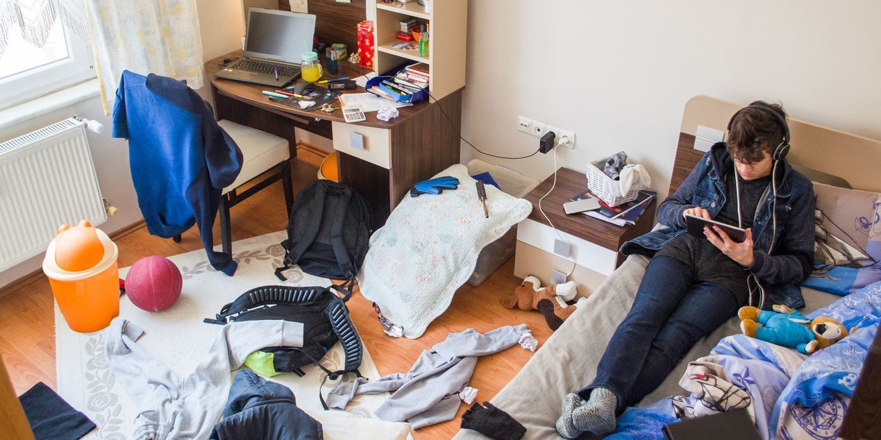 teen sitting in bedroom refusing to go to school