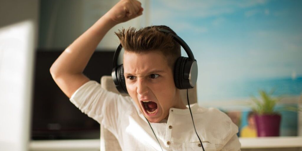 angry teen boy raising arm