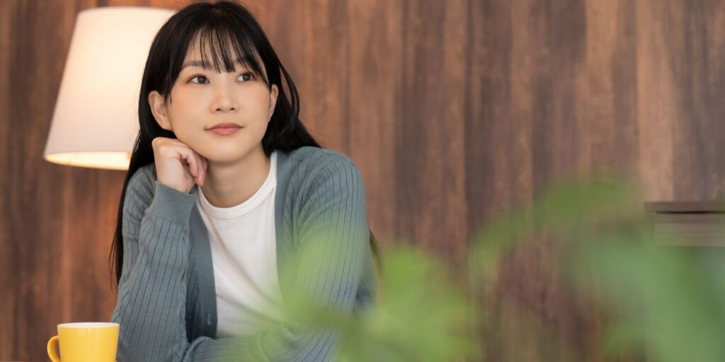 young woman sitting alone at home possibly depressed