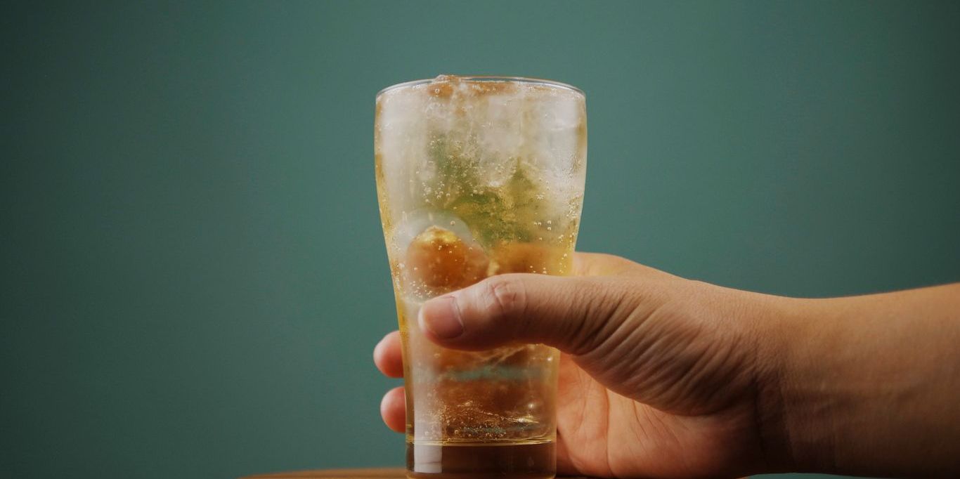 hand holding soft drink soda